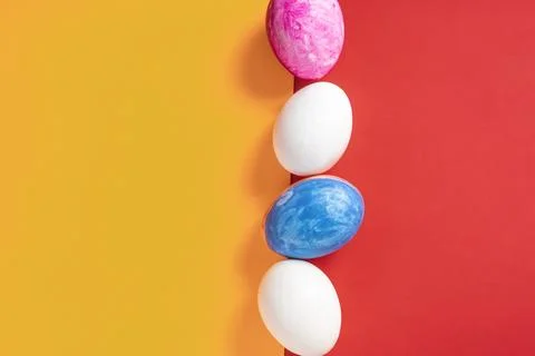 Colorful Easter eggs on split yellow and red background Stock Photos