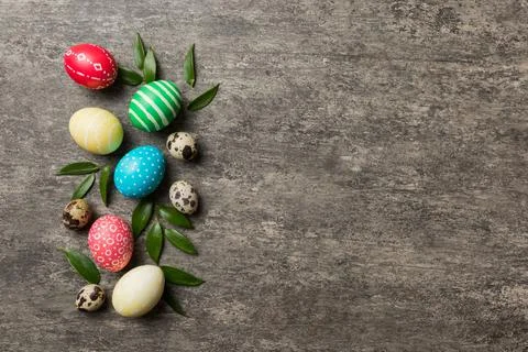 Colorful Easter eggs with spring flower leaf isolated over white background.  库存照片