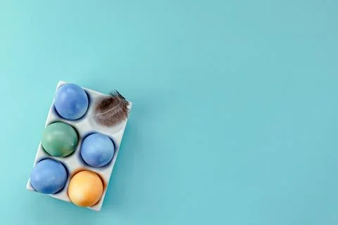 Colorful Easter eggs in a stand on a blue background Stock Photos