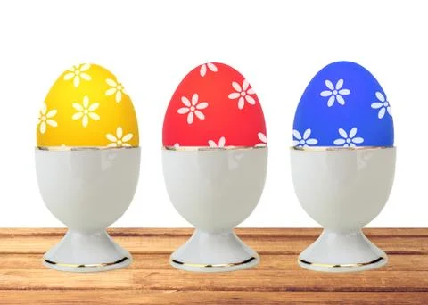 Colorful Easter Eggs in stand on table isolated on white Stock Photos