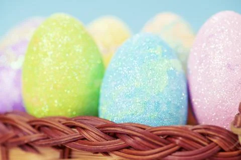 Colorful easter eggs on a stand on a table on a blue background Stock Photos