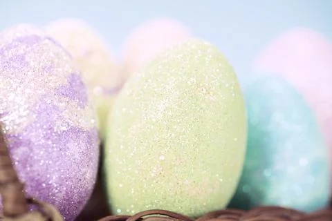 Colorful easter eggs on a stand on a table on a blue background Stock Photos