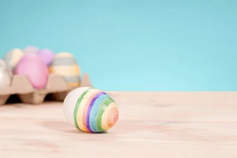 Colorful easter eggs on a stand on a table on a blue background Stock Photos