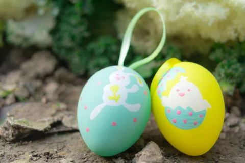 Colorful easter eggs standing on the ground, ready for the egg hunter traditi Stock Photos