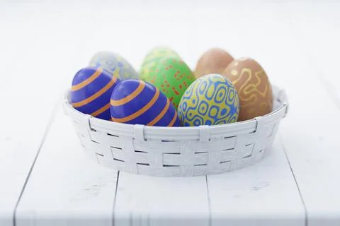 Colorful Easter eggs in a white basket on a wooden table. Easter still life.  Stock Illustration