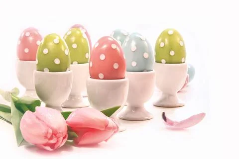 Colorful easter eggs in white cups Stock Photos