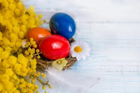 Colorful Easter eggs on a white dish in the shape of hearts and flowers of Stock Photos