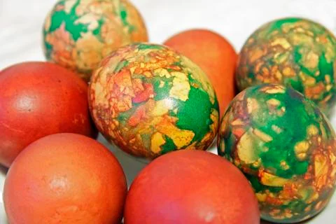 Colorful Easter eggs on white plate placed by heap Stock Photos