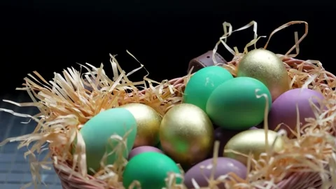 Colorful Easter Eggs in Wicker Basket with Straw. A wicker basket filled wi.. Video stock 331215074