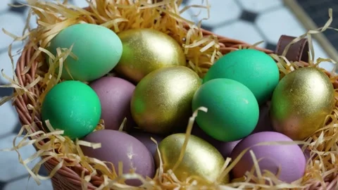 Colorful Easter Eggs in Wicker Basket with Straw. A wicker basket filled wi.. Stock Footage 331215077