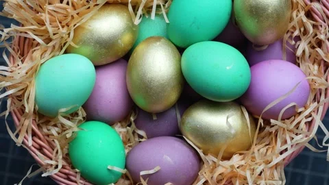 Colorful Easter Eggs in Wicker Basket with Straw. A wicker basket filled wi.. Stock-Footage 331215089
