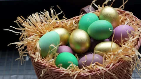 Colorful Easter Eggs in Wicker Basket with Straw. A wicker basket filled wi.. Stock-Footage 331215090