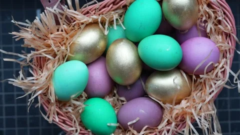 Colorful Easter Eggs in Wicker Basket with Straw. A wicker basket filled wi.. Stock-Footage 331215117