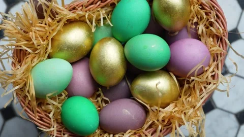 Colorful Easter Eggs in Wicker Basket with Straw. A wicker basket filled wi.. 스톡 동영상 331215999