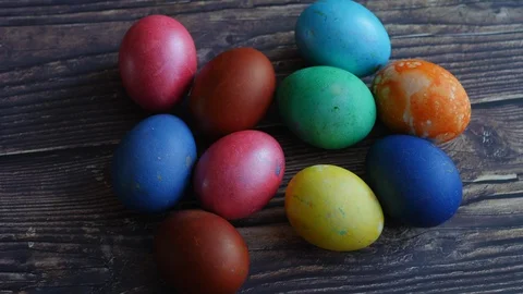 Colorful Easter Eggs On A Wooden Background Slider Shot. Natural Daylight.. Stock Footage 128192368