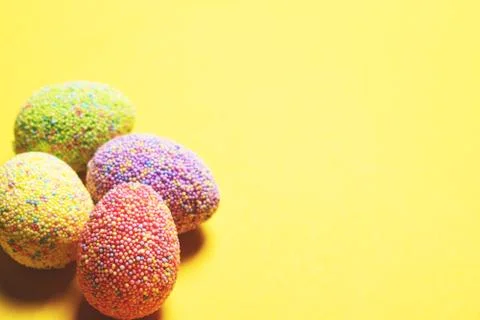 Colorful easter eggs on yellow background. Stock Photos