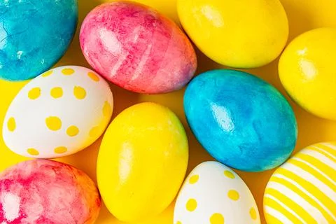 Colorful easter eggs on a yellow background flat lay. Happy easter Stock Photos