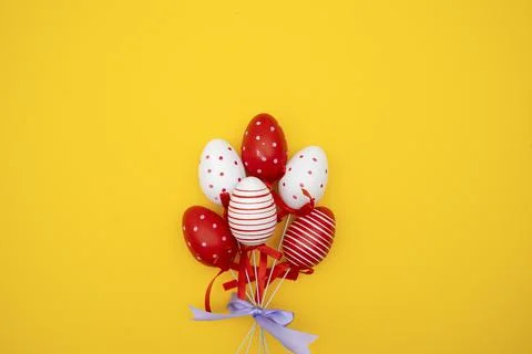 Colorful Easter eggs on yellow background Stock Photos