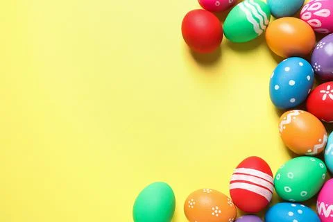 Colorful Easter eggs on yellow background, flat lay. Space for text Foto stock