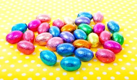 Colorful easter eggs on yellow dotted napkin Stock Photos