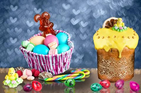 Colorful Easter set with eggs, cake and sweets on a defocused background with Фото
