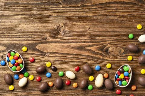 Colorful Easter sweets on rustic wooden table Stock Photos