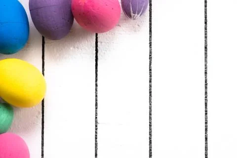 Colorful ecological styrofoam Easter eggs on a white wooden background. Frame Stock Photos