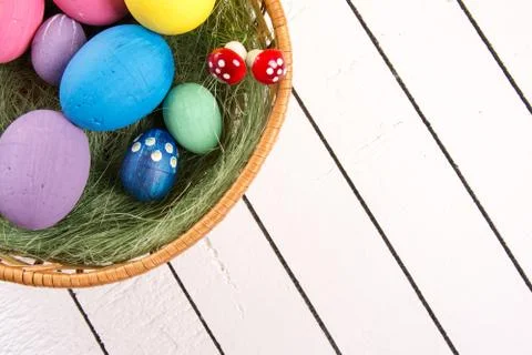 Colorful ecological styrofoam Easter eggs in basket on a wooden background Stock Photos