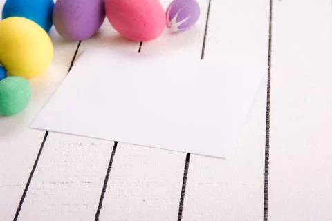 Colorful ecological styrofoam Easter eggs and blank white sheet of wood Stock Photos