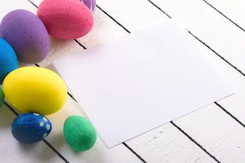 Colorful ecological styrofoam Easter eggs and blank white sheet of wood Foto stock