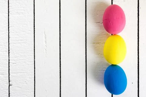 Colorful ecological styrofoam Easter eggs on a white wooden background. Frame Stock Photos