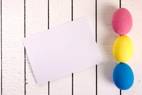 Colorful ecological styrofoam Easter eggs and blank white sheet of wood Stock Photos