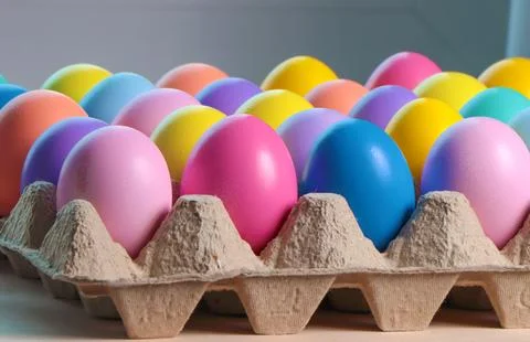 Colorful eggs in egg cartons for Easter. Stock Photos