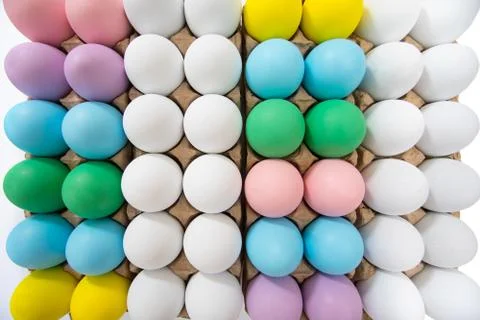 Colorful eggs in egg crate, flat lay view on a wide angle 스톡 사진
