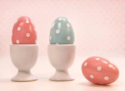 Colorful eggs in white cups Stock Photos