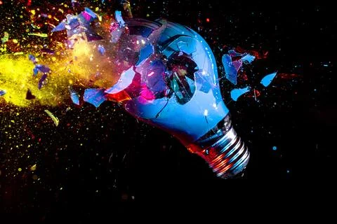 Colorful electric light bulb exploding Stock Photos