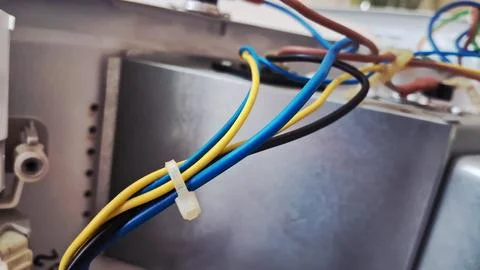 Colorful electrical wires connected inside a metallic industrial machine housing Stock Photos