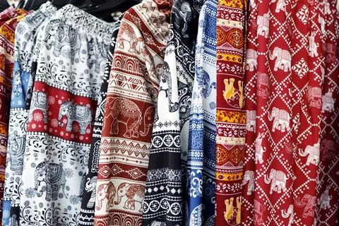 Colorful elephant patterned fabrics hanging in row, showcasing Asian textil.. Stock Photos