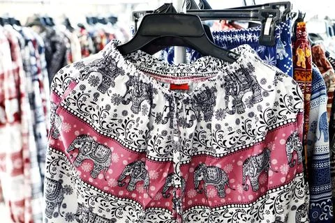 Colorful elephant patterned pants hanging on rack, Hawaii pant, Asian fashi.. Stock Photos