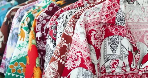 Colorful elephant patterned shirts hanging on rack, Hawaii shirt Stock Footage 332920485