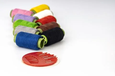 Colorful Embroidery Thread Spools with Red Needle Threader Tool for Sewing Stock Photos