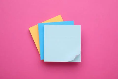Colorful empty notes on pink background, top view Stock Photos