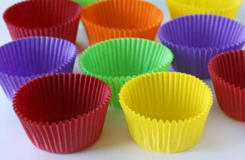 Colorful empty paper forms capsules for muffins and cupcakes on white Stock Photos