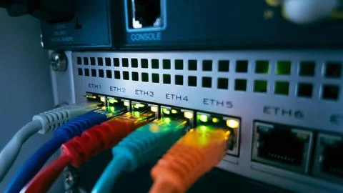 Colorful ethernet cables connected to network switch, symbolizing high spee.. Foto stock