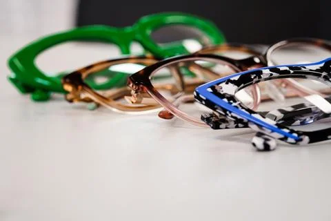 Colorful Eyeglasses Frames Lined Up On White Surface Closeup View Detail Te.. Stock Photos