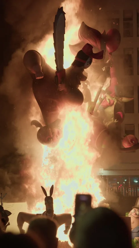 Colorful falla sculpture engulfed in fire during Las Fallas La Crema Valencia Stock Footage 336275980