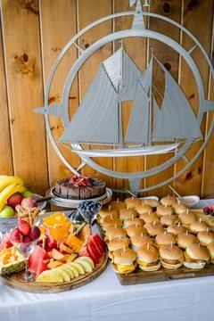 Colorful feast by the sea. A delightful array of food featuring burgers, fr.. Stock Photos