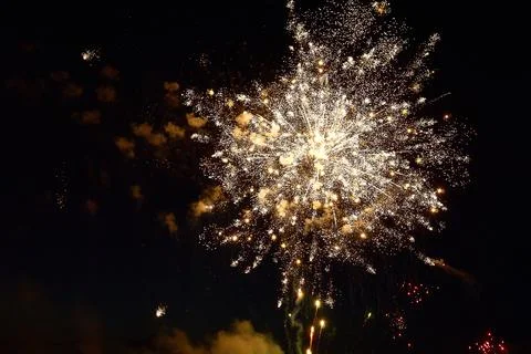 Colorful festive fireworks on a black sky background. Stock Photos