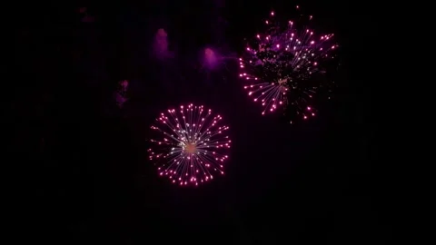 Colorful festive fireworks explode against the black sky. Stock Footage 340587201