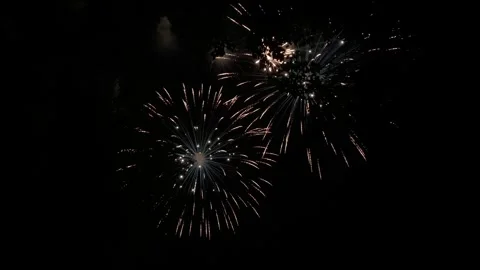 Colorful festive fireworks explode against the black sky. Stock Footage 340587611
